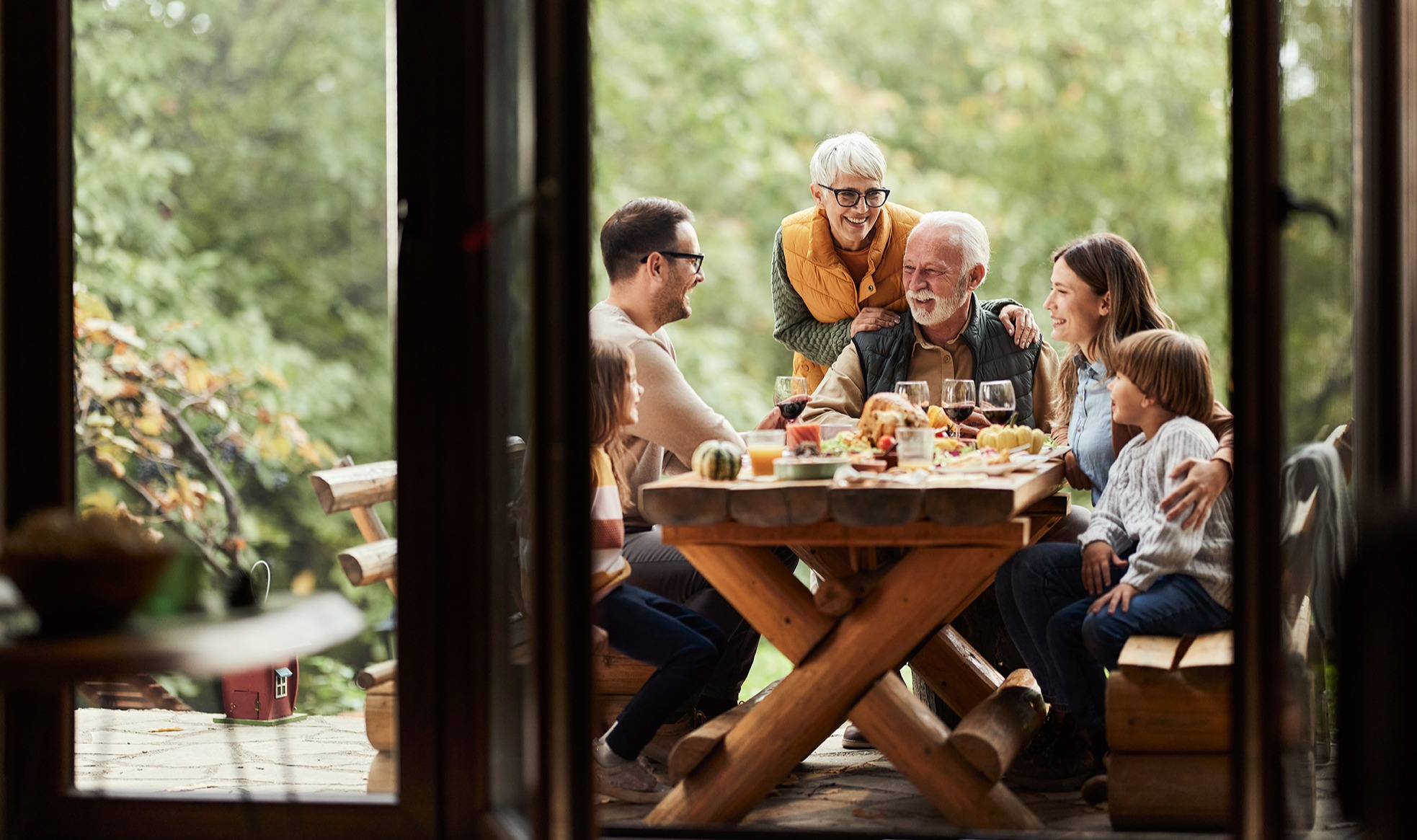 Happy extended family enjoying in lunch on a terrace.