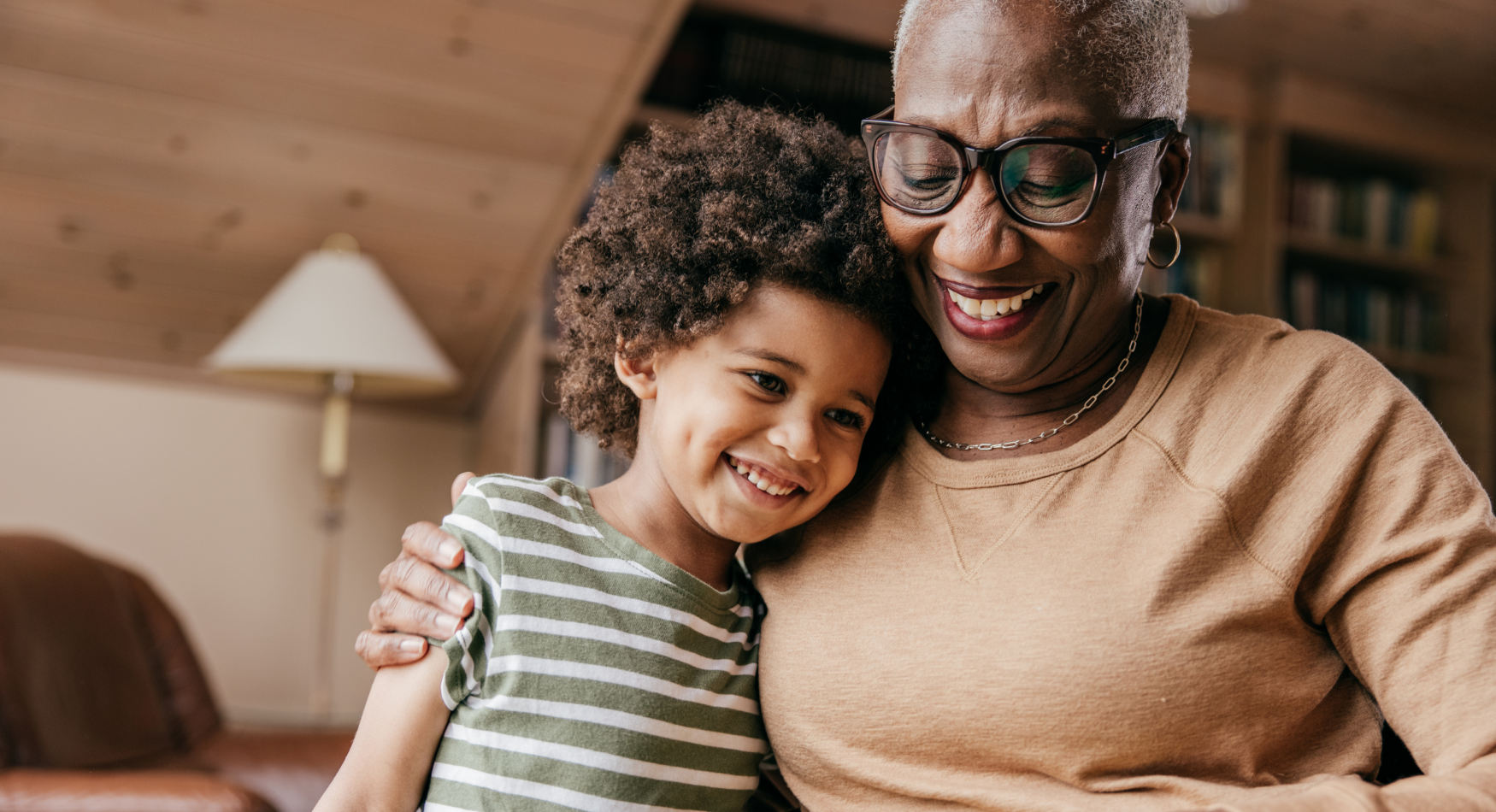 Affectionate young woman talking to elderly woman in a wheelchair in the garden